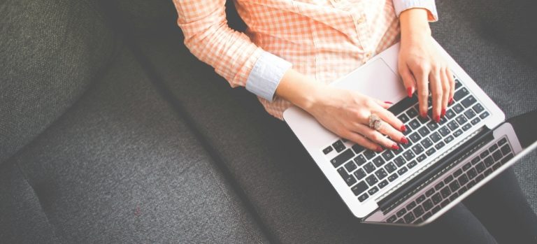 woman reading about the efficient home organization on her laptop