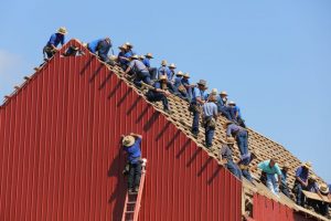 A lot of men working on a roof in Florida